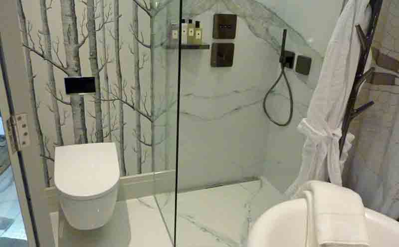 Luxury walk-in shower by Harrods featuring Porcel-Thin Calacatta book matched marble effect thin porcelain wall tiles