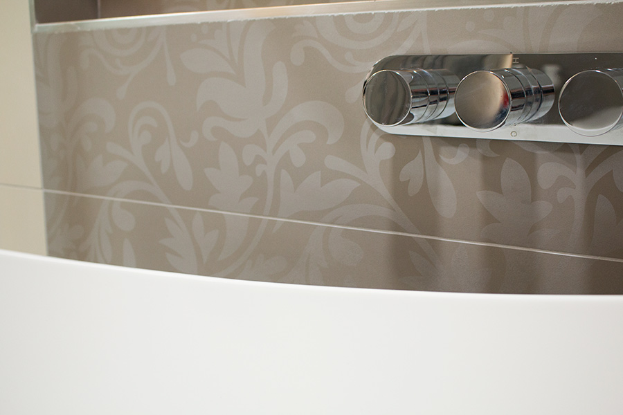 This over bath shower features designer Porcel-Thin tiles and recessed shower controls for a sleek modern look