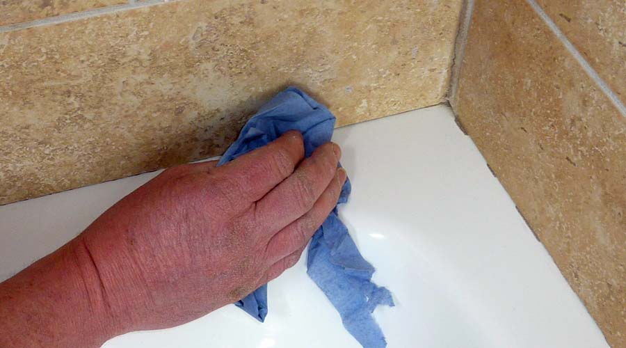 Dry the shower tray and tiles with paper towel ensuring that all mositure has been removed before applying silicone sealant