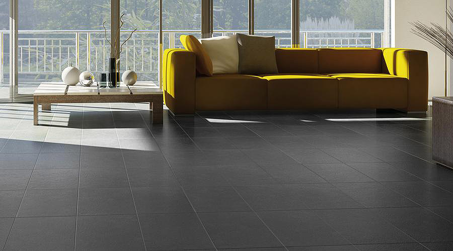 Marazzi Iside black concrete look floor tiles in a brigh and modern lounge
