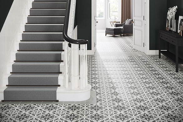 geometric floor tiles used to create a rug effect with light grey boarder tile