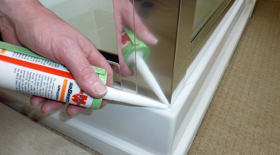 Silicone sealant being applied to the outside of a shower enclosure