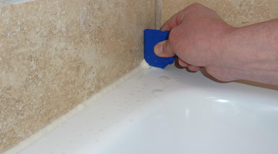 A Fugi silicone sealant application tool is used to remove excess sealant and leave a neat line around the perimeter of the shower tray