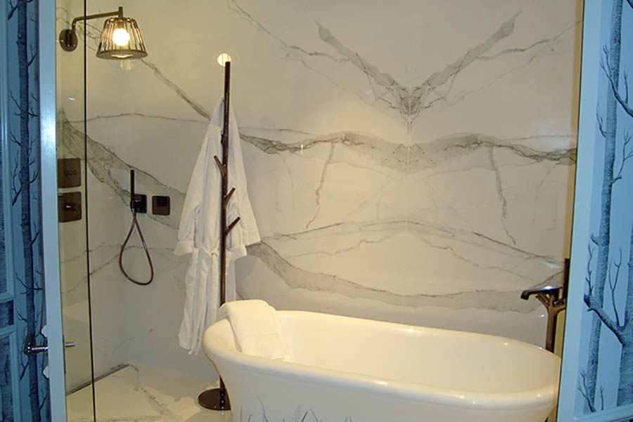 White Calacatta marble look book matched 120x60cm thin porcelain tiles by Porcel-Thin in a luxury bathroom