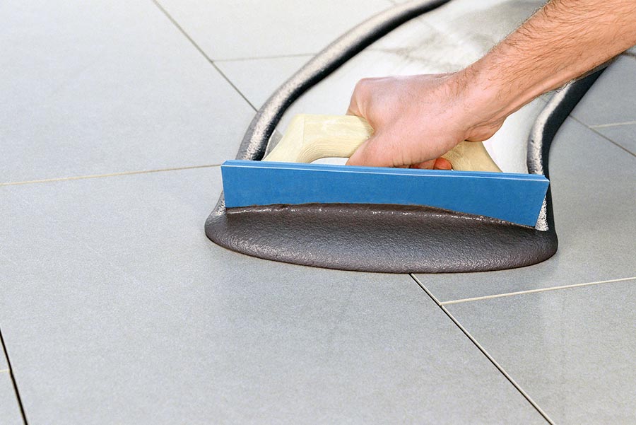 Grouting grey floor tiles with Kerakoll Fugalite Bio silver grey grout