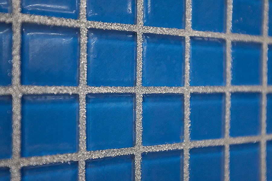 Silver glitter grout with deep blue glass mosaic tiles