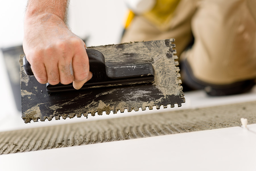 A UK Tiles Direct installing porcelain kitchen floor tiles in Dorset