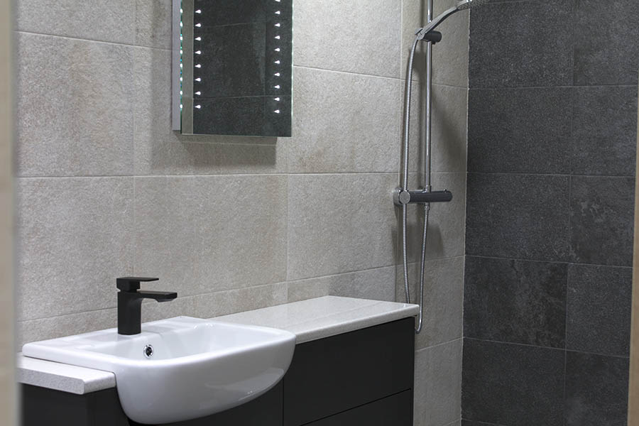 Marazzi Stoneway stone effect black and blanco contrasting tiles on the wall of a luxury shower room display at UK Tiles Direct Wareham